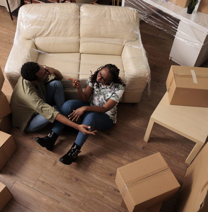 Romantic people relaxing together on living room floor, talking about decorations and future family. Enjoying relocation and taking break after moving in, relationship achievement. Top view of.